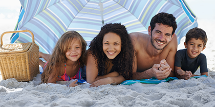 Family under a beach umbrella